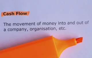 Picture depicting the meaning of cash flow with an orange marker - Miedema's Board Consulting Toronto