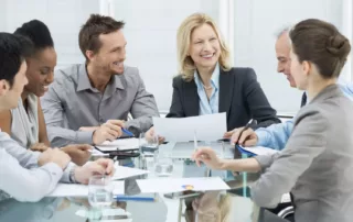 In-Camera | Group Of Happy Coworkers Discussing In Conference Room